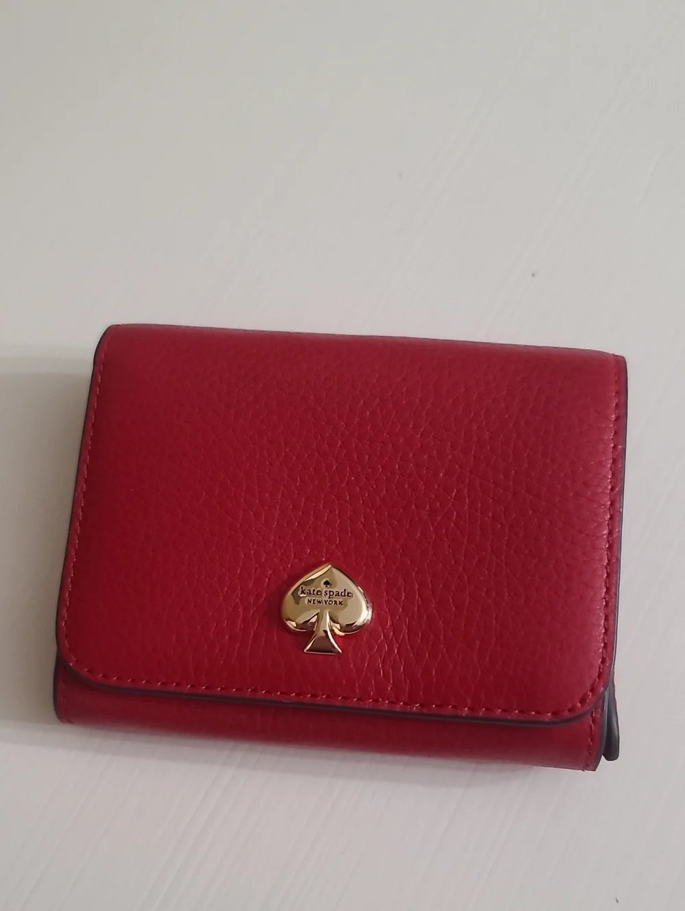 kate spade red pebbled leather trifold wallet with gold spade logo